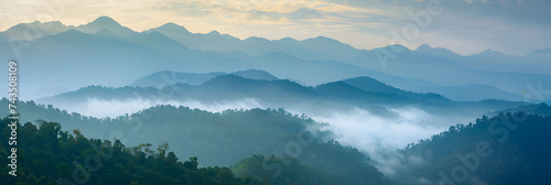 Amazing wild nature view of layer of mountain forest landscape with cloudy sky. Natural green scenery of cloud and mountain slopes background. Maehongson,Thailand. Panorama view. © john