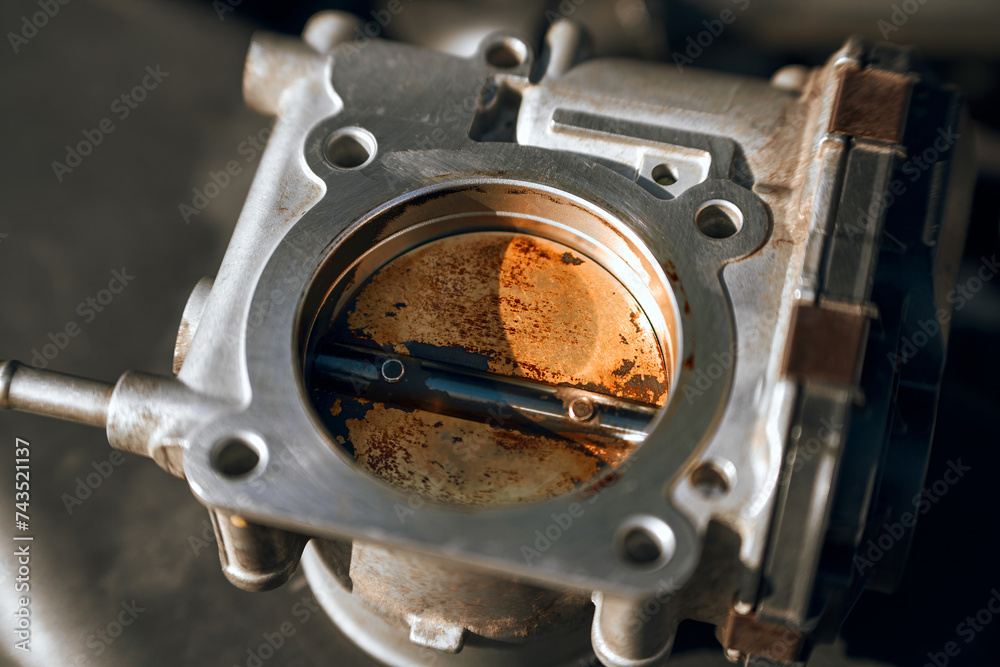 carbon deposits damage a throttle valve of a car engine. The valve