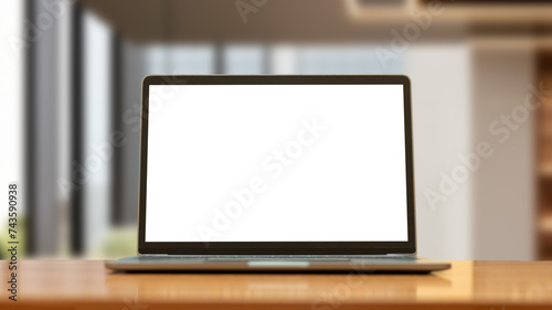 Laptop computer on desk at office or co-working space, Laptop with white blank on screen and blurred background , working space concept.