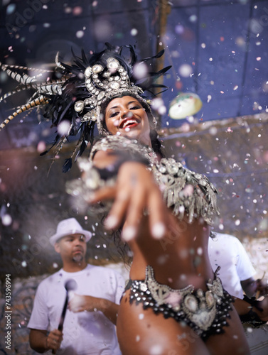 Dance, performance and woman samba at carnival, festival and event in Brazil for summer celebration of culture. Happy, dancer and creative fashion for salsa, party and night with confetti and music