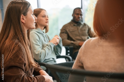 Conception of mental health, sitting and talking. Group of people are having therapy meeting together © standret