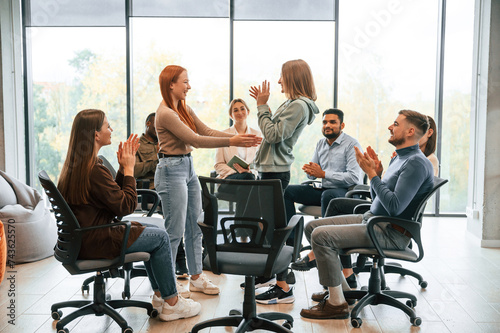 Greeting each other. Group of people are having therapy meeting together