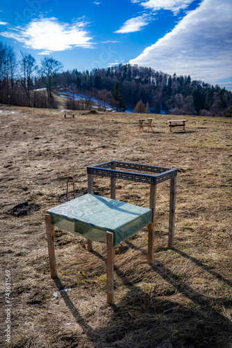 Temporary tables for picnic and bbq in mountains. Wierchomla, Beskid Sadecki in early spring. photo