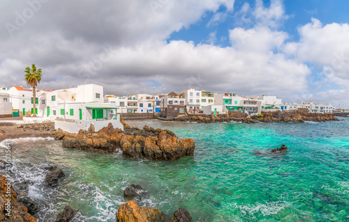 Obraz na płótnie Explore Punta Mujeres in Lanzarote: a charming coastal village where crystal clear waters hug quaint white houses against a rugged landscape. w salonie