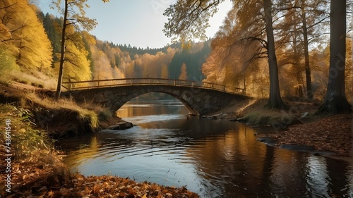 bridge in autumn A romantic view of a landscape in autumn. A lake bridge in a woodland. A road through gold forests.