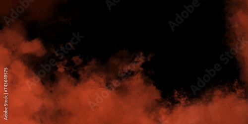 Abstract orange powder explosion on black background. Freeze motion of orange dust particles splash. fire with smoke on a black background. scare, dreamy red and black cloud in the sky background.