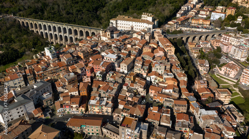 Aerial view of the bridge and the historic center of Ariccia, in the Metropolitan City of Rome, Italy. The houses of the town are built between the traditional alleys on the hill near Italian capital.