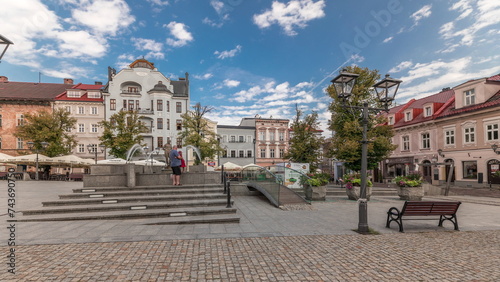 Panorama showing Neptune fountain on Old Town Market Square timelapse with historical houses around. photo