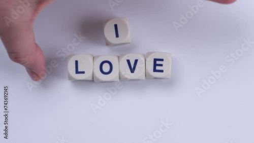 Wallpaper Mural female hand lays text i love you from cubes with letters on a white background Torontodigital.ca