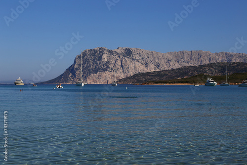 Tavolara Island, yachts and catamarans in Capo Coda Cavallo beach near San Teodoro in Sardinia, Italy photo