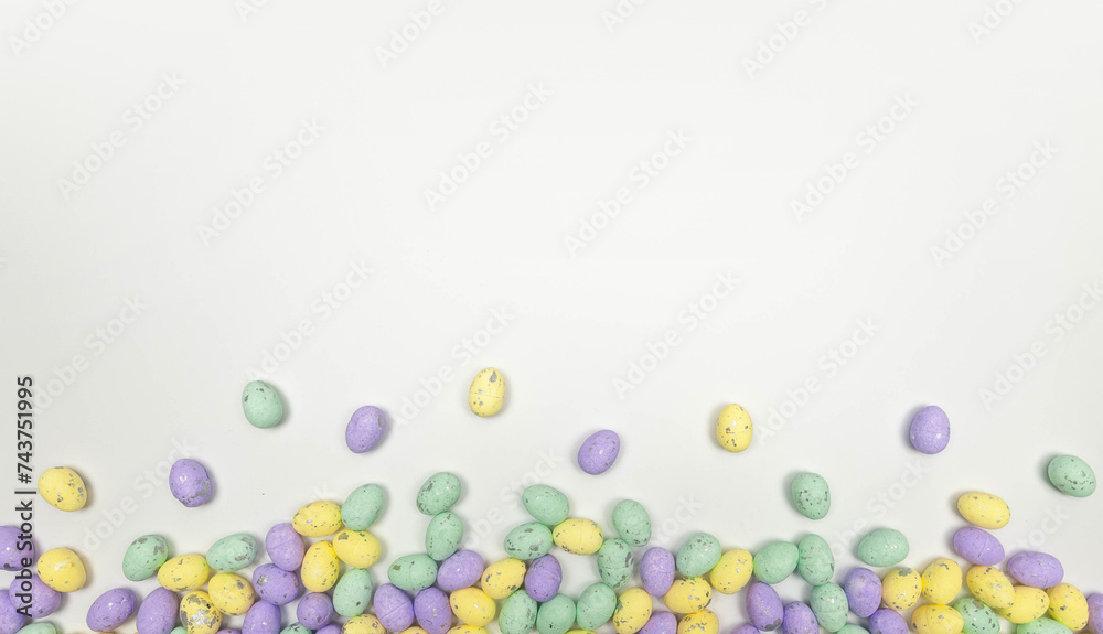 Top view of colourful easter eggs on white background. Creative easter composition, spring, copy space, flat lay.
