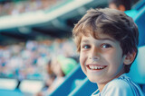 Photo of happy boy at the stadium watching match.