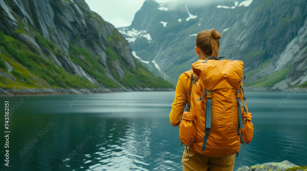 Serene Wanderlust: Woman Admiring Lake in Yellow Backpack