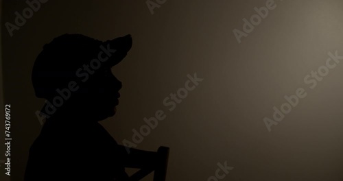 Witness anonymous woman being interviewed in a dark room. photo