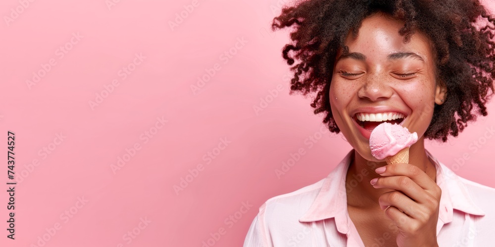 Cropped of african american woman eating ice cream isolated on pink background