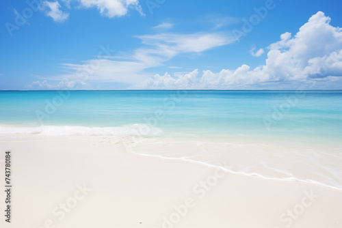 White sandy beach with waves at the ocean, clouds