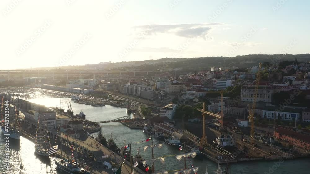 Aerial view Tall Ship race Lisboa Sailing ships at Lisbon port with cityscape in background. Sailing ship race panning shot drone. Aerial view Tall Ship race Lisboa Sailing ships at Lisbon port with cityscape in background. Sailing ship race panning shot drone.