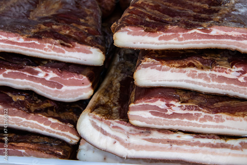 Exposed bacon and dried meat domestic products presented for sale on a farmer's market in Kacarevo village, gastro bacon and dry meat products festival called Slaninijada (bacon festival) held yearly  photo