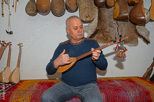 A man playing the traditional Turkish musical instrument Cura. photo