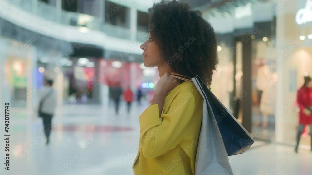 Side view multiethnic woman walking shopping center inside looking showcase thinking choosing store boutique discounts offer brand things clothes contemplation trendy consumer shopaholic girl dilemma Side view multiethnic woman walking shopping center inside looking showcase thinking choosing store boutique discounts offer brand things clothes contemplation trendy consumer shopaholic girl dilemma