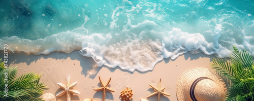Closeup view of the seashore with straw hat and shells lying on it in summertime. Vacation, tourism, background and banner concept.