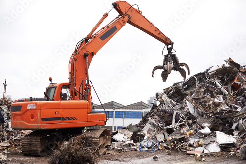 Crane, vehicle and junkyard to recycle metal with sustainability, manufacturing and stop pollution. Machine, tractor and scrapyard for ecology at plant with iron, steel and industry in environment