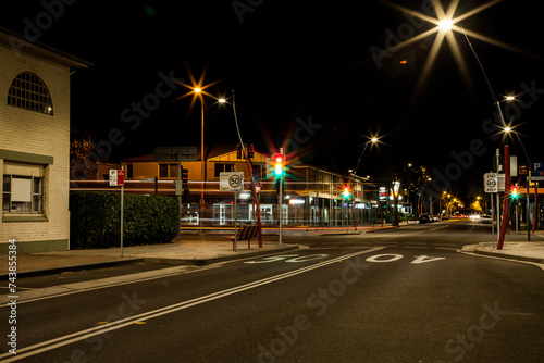 Red orange and green traffic lights in a small town at night