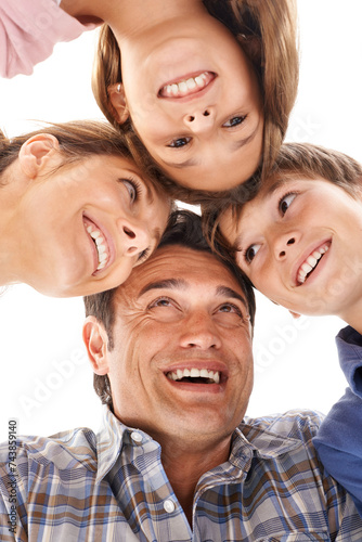 Face of mother, father and children on a white background for bonding, relationship and love. Family, happy and low angle of isolated mom, dad and kids for support, care and together in studio