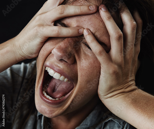 Fotografie Face, horror and phobia with woman screaming in studio on black background for reaction to fear