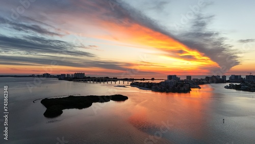 A beautiful sunset orange sky from a drone view of Clearwater Beach, Florida