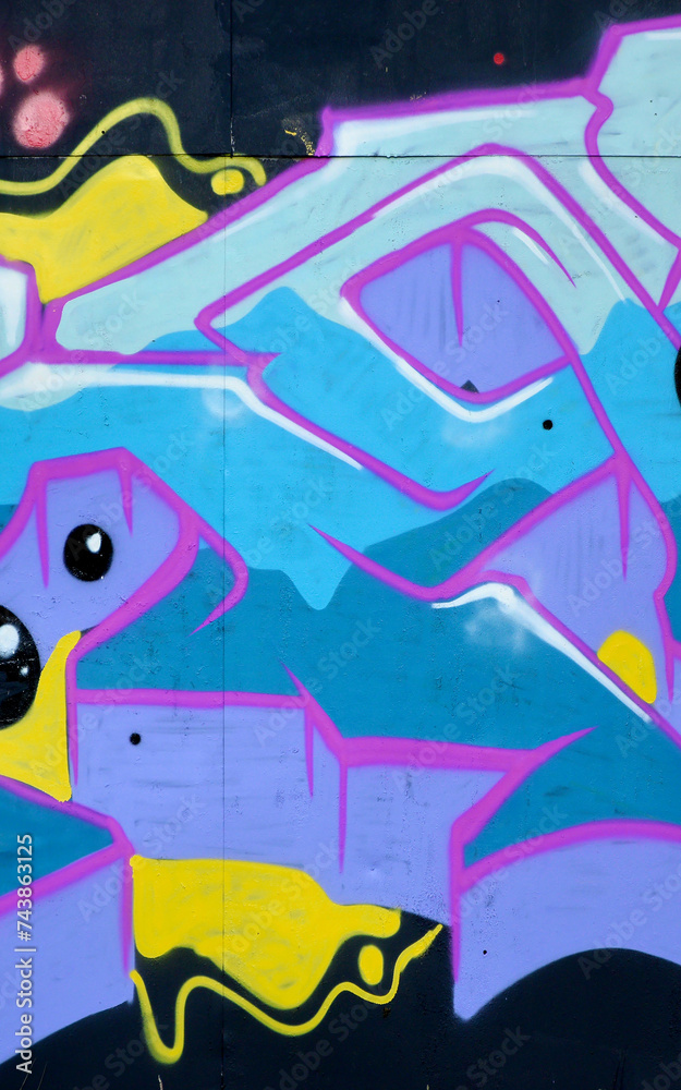 Colorful background of graffiti painting artwork with bright aerosol outlines on wall. Old school street art piece made with aerosol spray paint cans. Contemporary youth culture backdrop