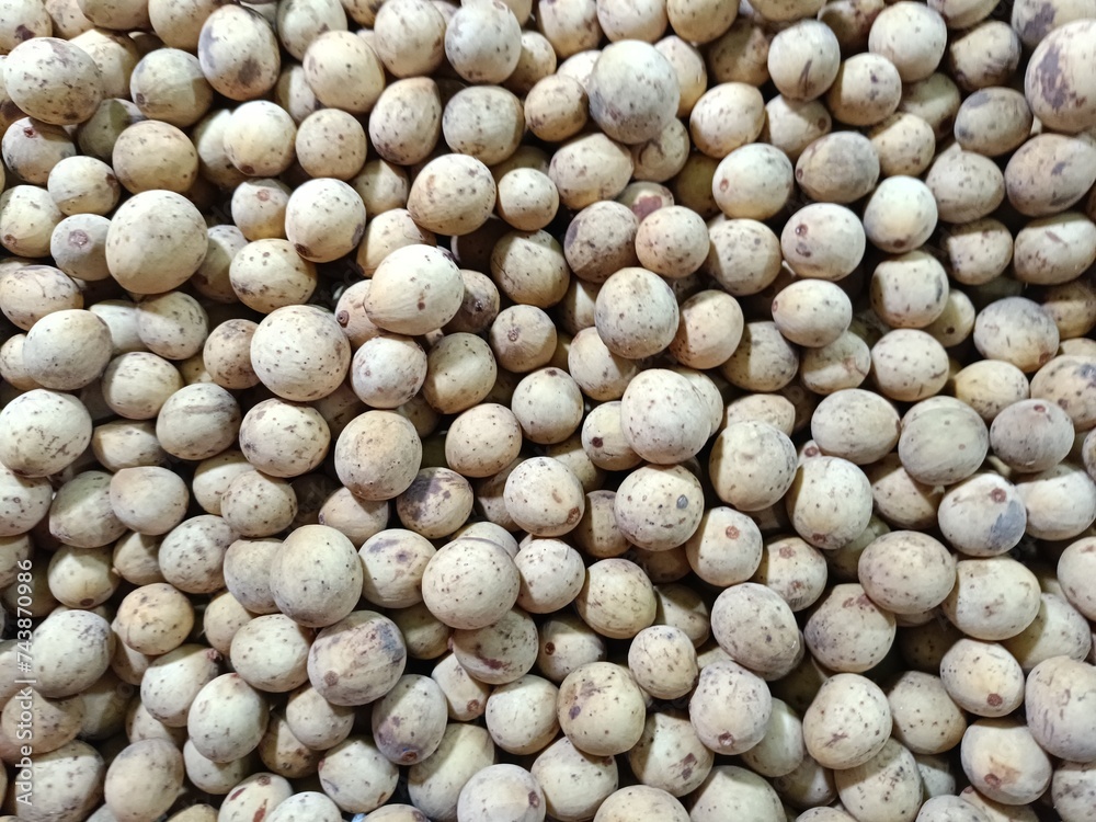 A full-frame photo of a pile of langsat (duku) fruit suitable for a fruit-themed or market-themed background A full-frame photo of a pile of langsat (duku) fruit suitable for a fruit-themed or market-themed background