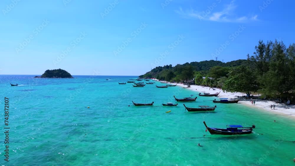 longtail boats in turquoise water on beach. Amazing aerial top view flight drone longtail boats in turquoise water on beach. Amazing aerial top view flight drone