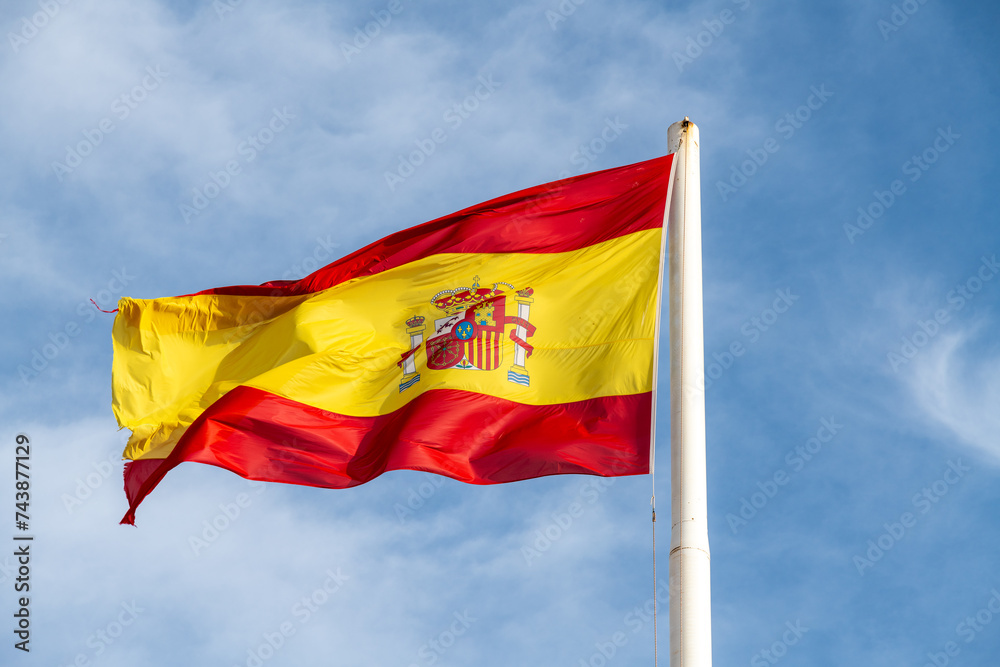 Spanish National Flag Waving Against Blue Sky Spanish National Flag Waving Against Blue Sky