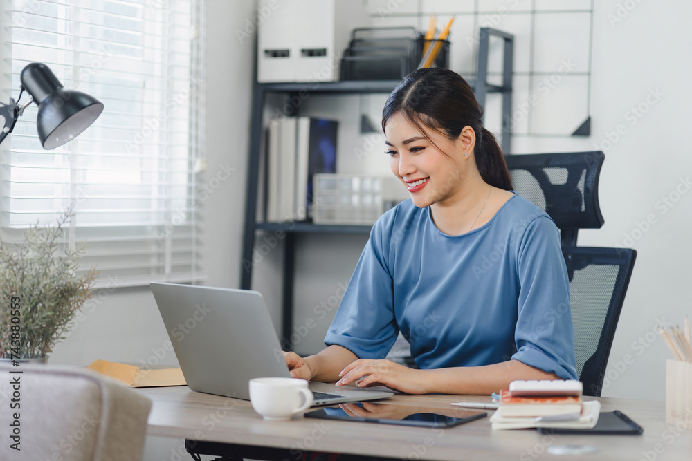 Concentrated young businesswoman studying or working on computer in modern home office. distant workday concept. Concentrated young businesswoman studying or working on computer in modern home office. distant workday concept.