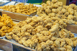 Trays of Golden Fried Chicken at a Food Market