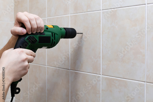 drilling tiles with a drill with a spear drill © Ocharonata