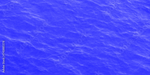 Modern Vivid deep blue water background. Transparent water in pool. Blue water with ripples on the surface. Defocus blurred blue water shining in the sea. rippled water detail background. 