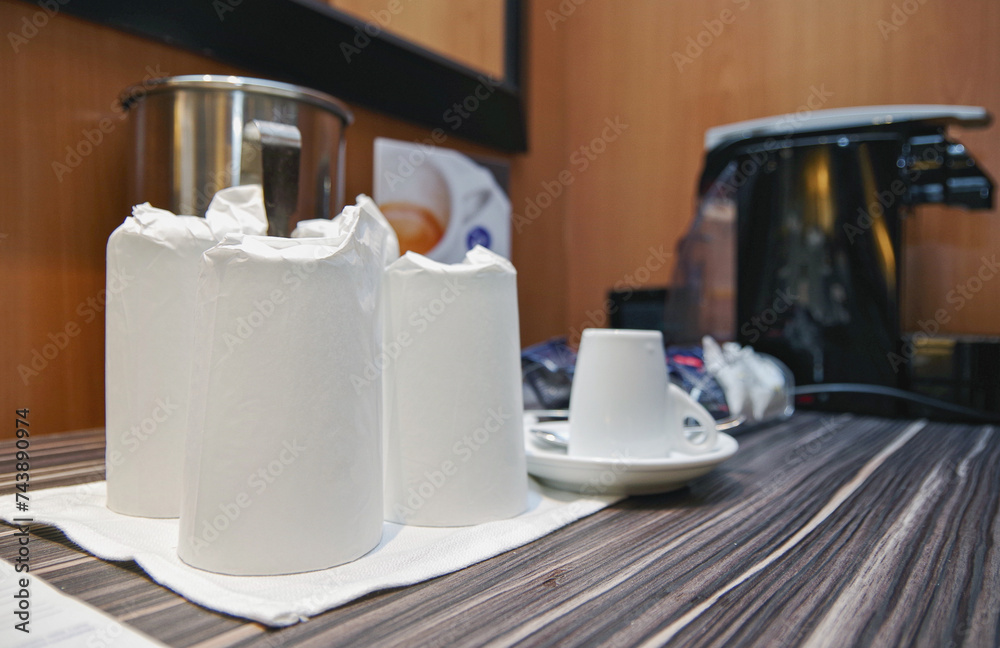 Close up view of Coffee espresso machine maker with cups and glasses on cupboard inside stateroom cabin suite onboard luxury cruiseship cruise ship liner - obrazy, fototapety, plakaty 