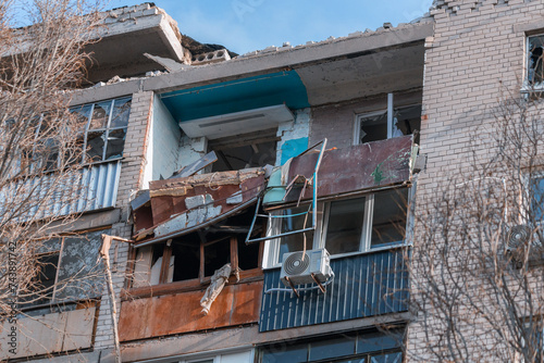 An attack drone (shahed) hit the roof of a house. Rocket attack on a residential building in the city of Dnepr. Consequences after a strong explosion. War in Ukraine and Russia. People under the rubbl photo