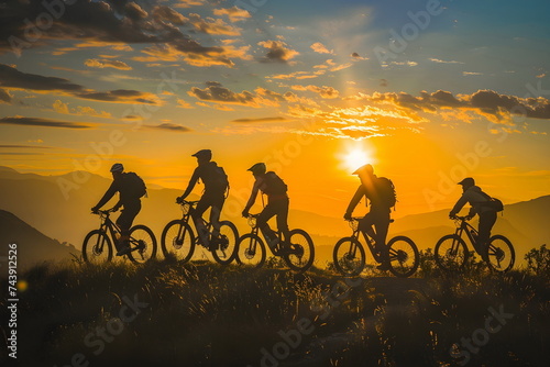 Bicyclists riding on a hill during sunset