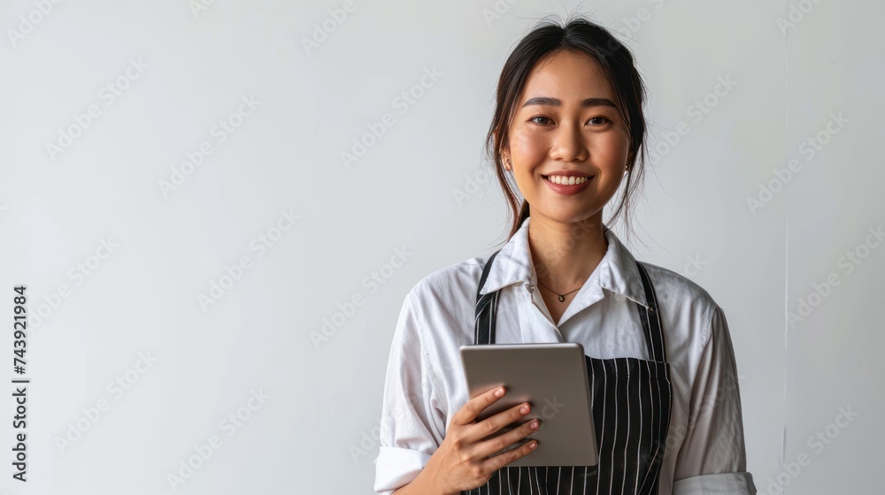 young smiling welcome asian female woman business owner wear apron hand holding tablet ready for your order on white color background, restaurant, pretty, uniform young smiling welcome asian female woman business owner wear apron hand holding tablet ready for your order on white color background, restaurant, pretty, uniform