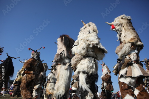 Bild auf Leinwand People called Kukeri parade in masks and ritual costumes, perform ritual dances to drive away evil spirits in the town of Elin Pelin, Bulgaria