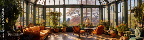 Sunlit Victorian orangery with armchairs and sofa among lush plants