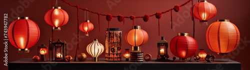 Red and orange glowing paper lanterns of various sizes and styles on a dark red background.