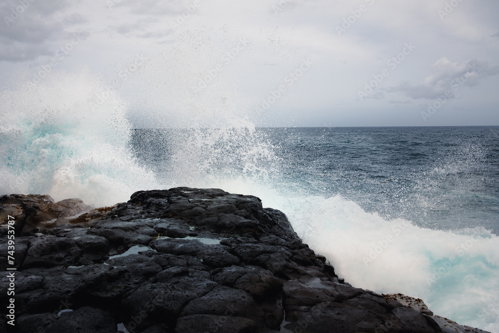 black coastline with waves on Kauai, Hawaii