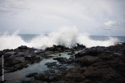 black coastline with waves on Kauai, Hawaii