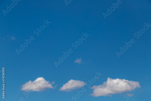 Blue sky with a few clouds background.