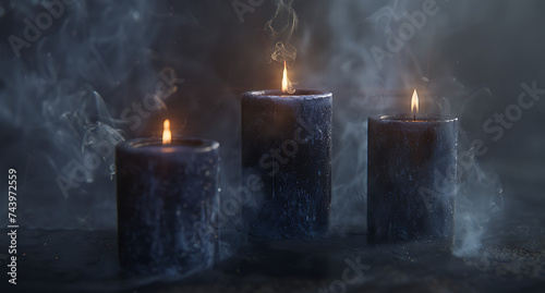 three candles glowing on a black background like in t photo
