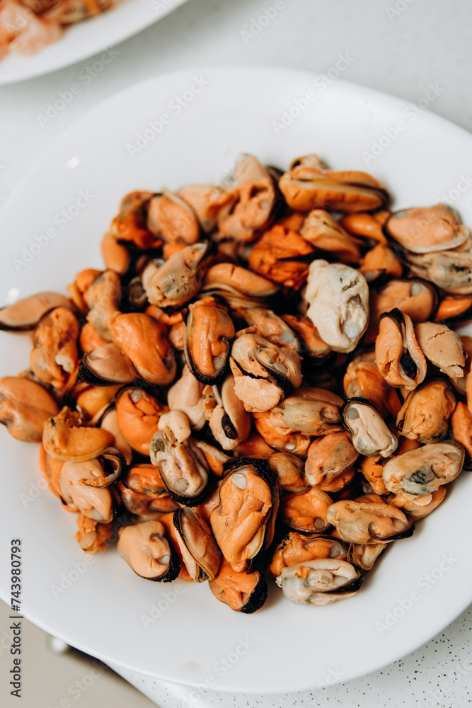 Delicious shrimp and mussels. Seafood on a white plate Delicious shrimp and mussels. Seafood on a white plate